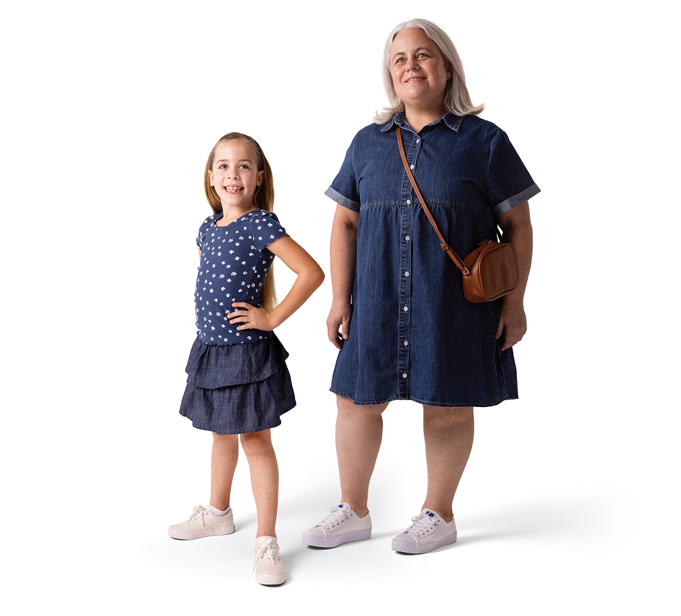 Cora and Aly, people living with XLH, standing next to each other
