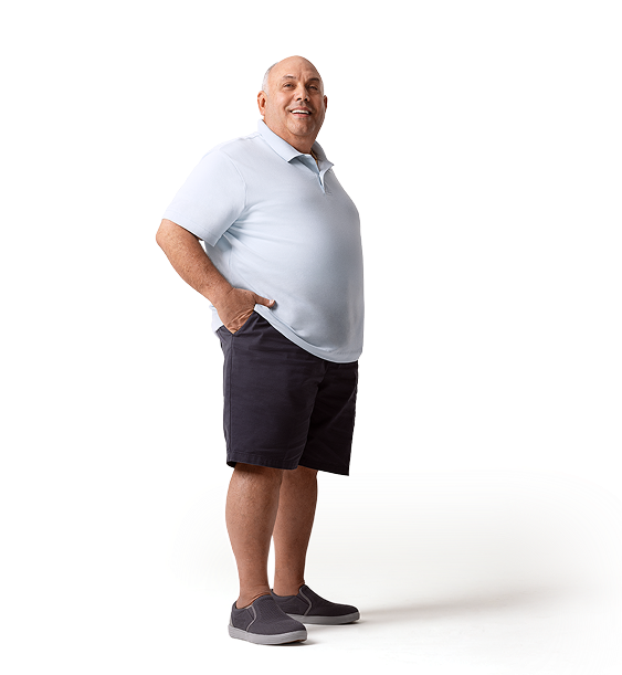 Gilberto, a patient currently on CRYSVITA, smiling while standing with his hand in his pocket 